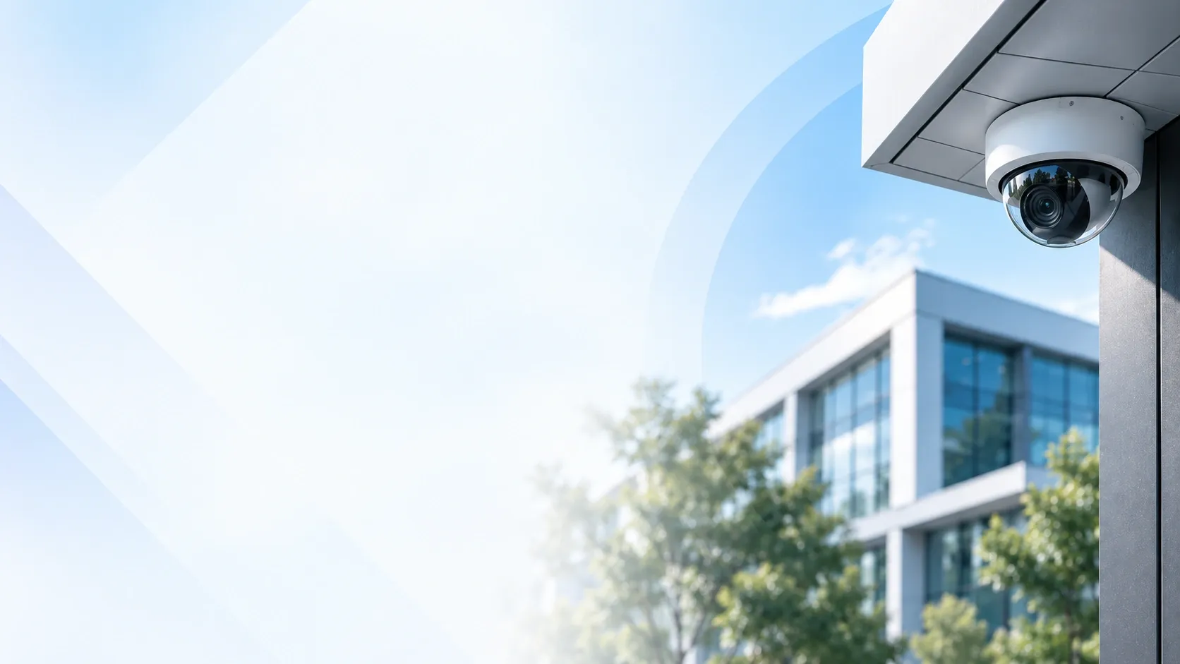 Dome security camera under a building canopy, overlooking a glass office.